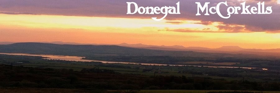 Sunset over the River Foyle and the hills of Donegal, with the title Donegal McCorkells